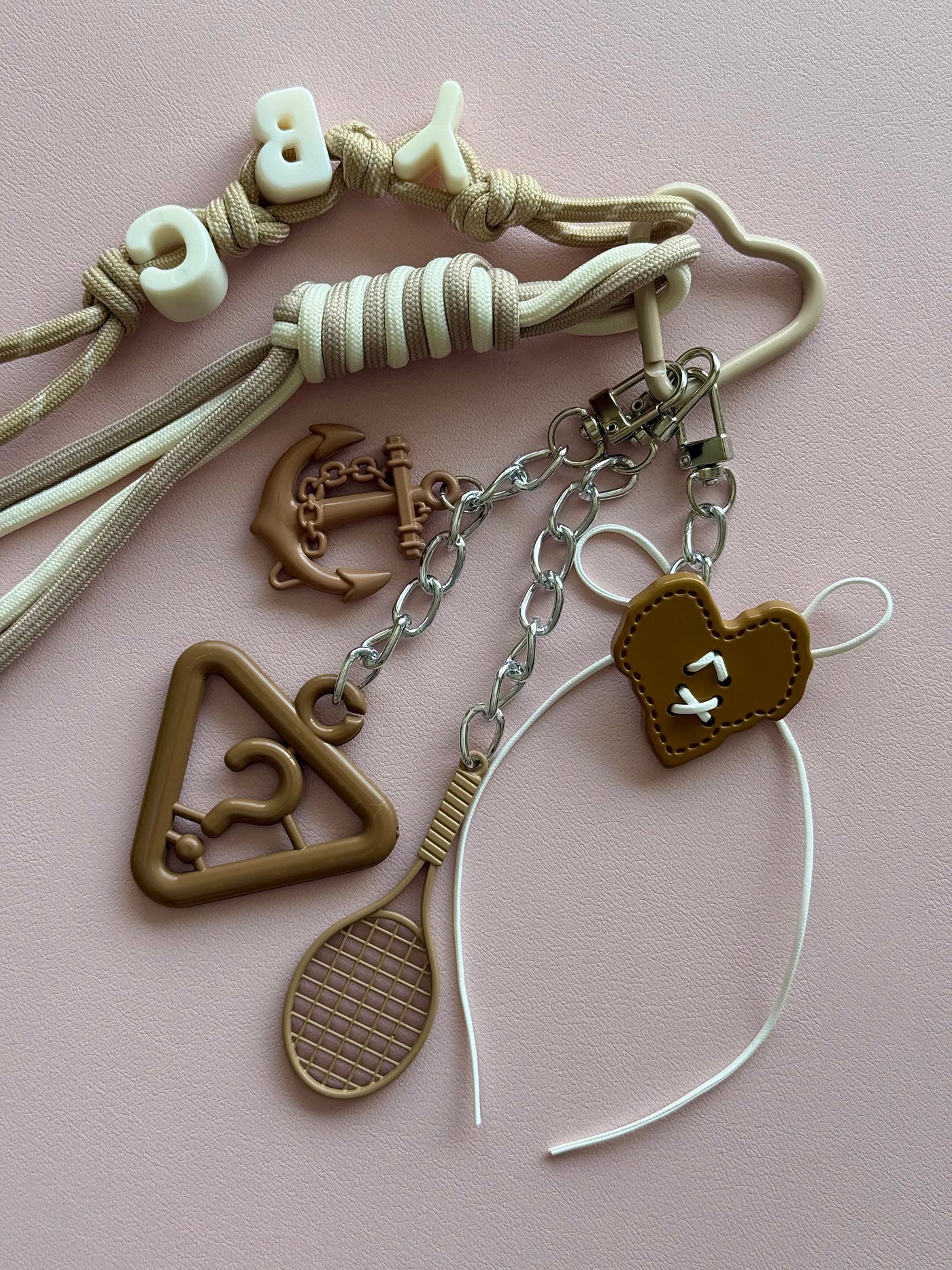 Beige "mystery of symbols" keychain