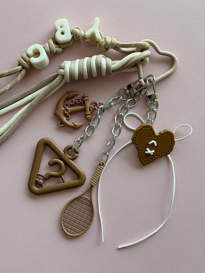 Beige "mystery of symbols" keychain