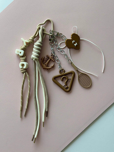 Beige "mystery of symbols" keychain